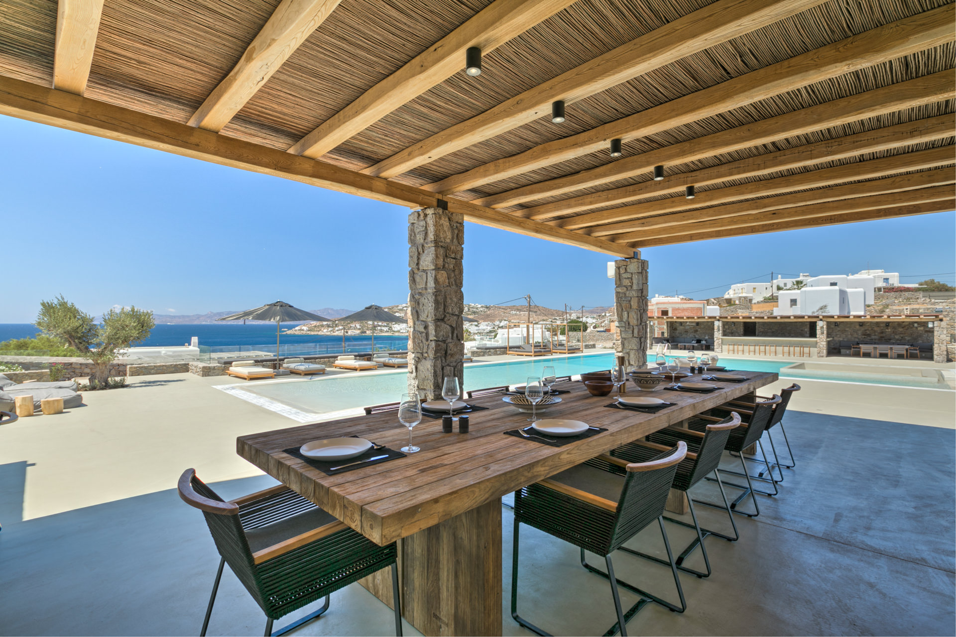 Outdoor dining table under the pergola at Villa Arion in Aleomandra, Mykonos