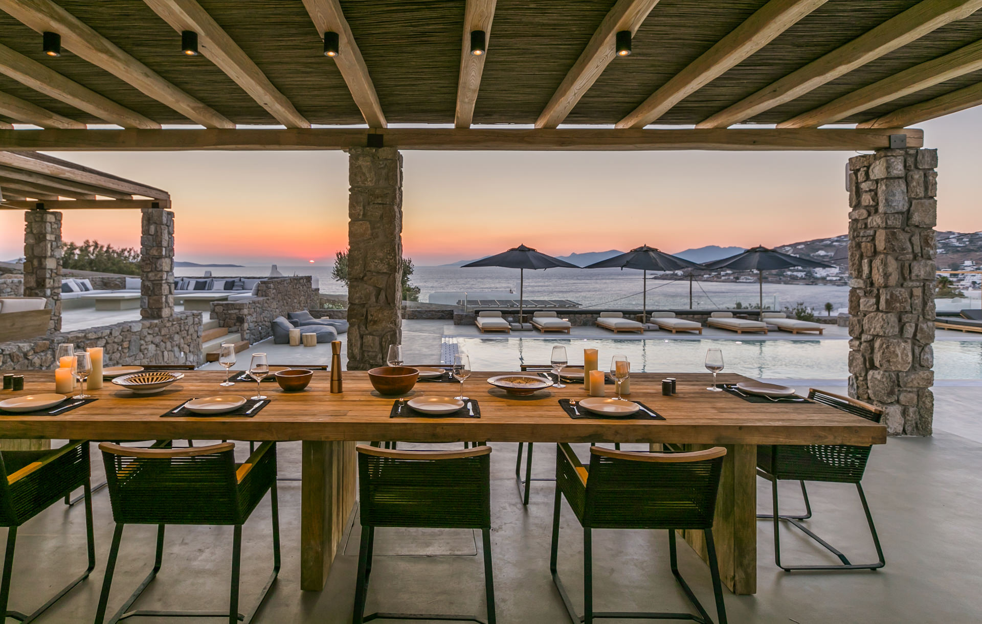 Outdoor dining table at sunset at Villa Arion in Aleomandra, Mykonos