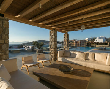 Covered outdoor lounge facing the pool at Villa Arion in Aleomandra, Mykonos