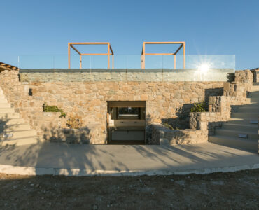Stone-built BBQ area below the pool terrace at Villa Arion in Aleomandra, Mykonos