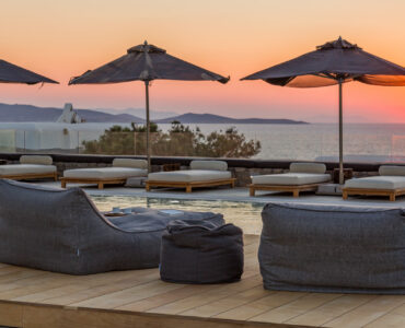 Bean bags and sun loungers at sunset at Villa Arion in Aleomandra, Mykonos