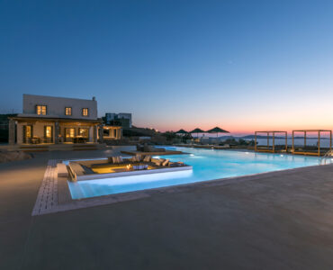 Pool and main house at dusk at Villa Arion in Aleomandra, Mykonos