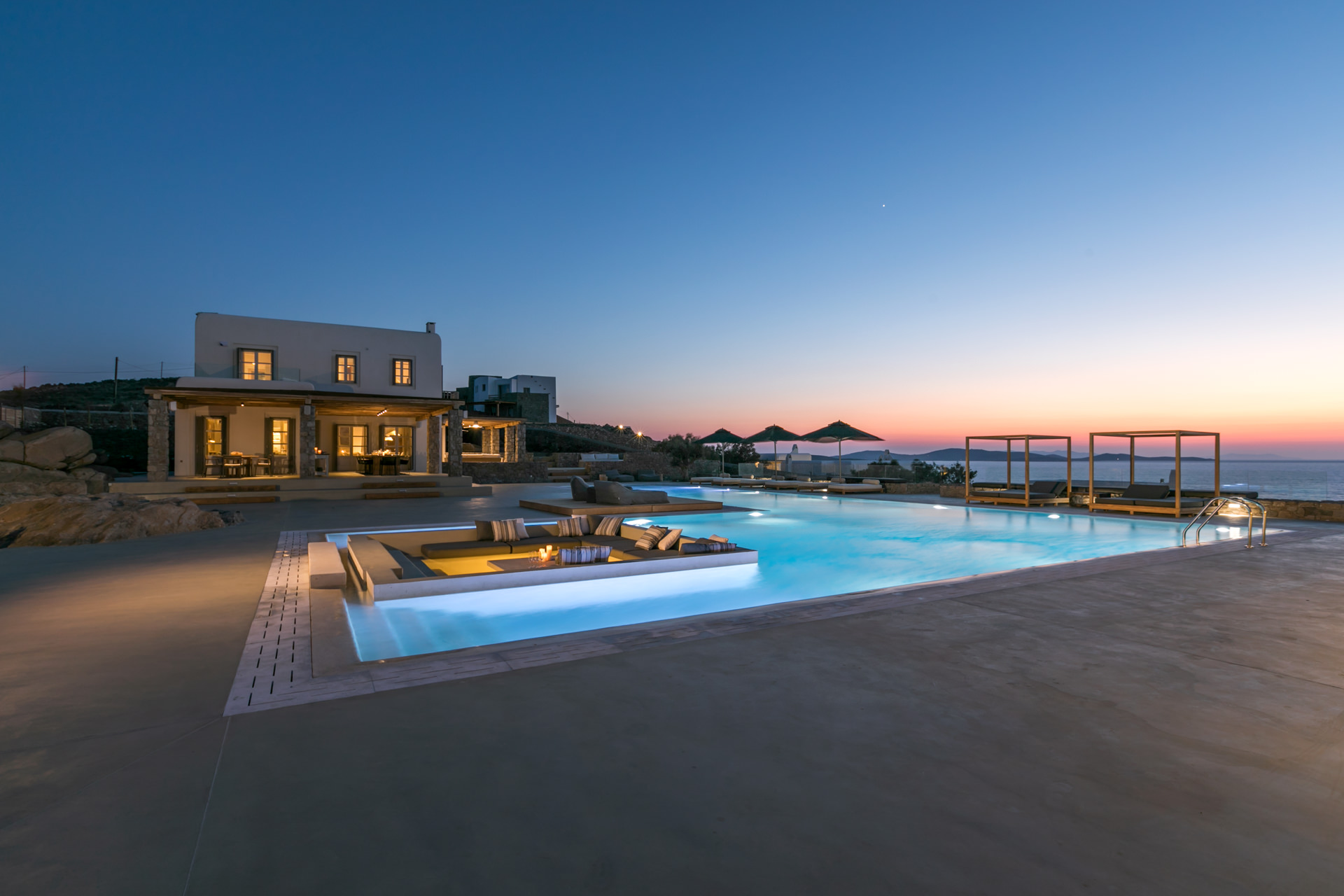 Pool and main house at dusk at Villa Arion in Aleomandra, Mykonos