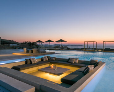 Sunken pool lounge lit at dusk at Villa Arion in Aleomandra, Mykonos