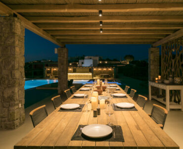 Outdoor dining table set for dinner at Villa Arion in Aleomandra, Mykonos