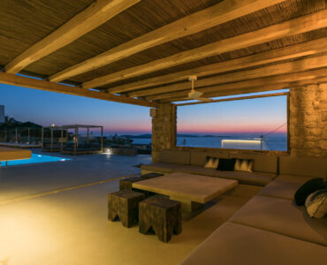 Covered lounge at dusk with sea view at Villa Arion in Aleomandra, Mykonos
