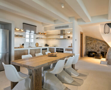 Dining table, kitchen and staircase at Villa Arion in Aleomandra, Mykonos
