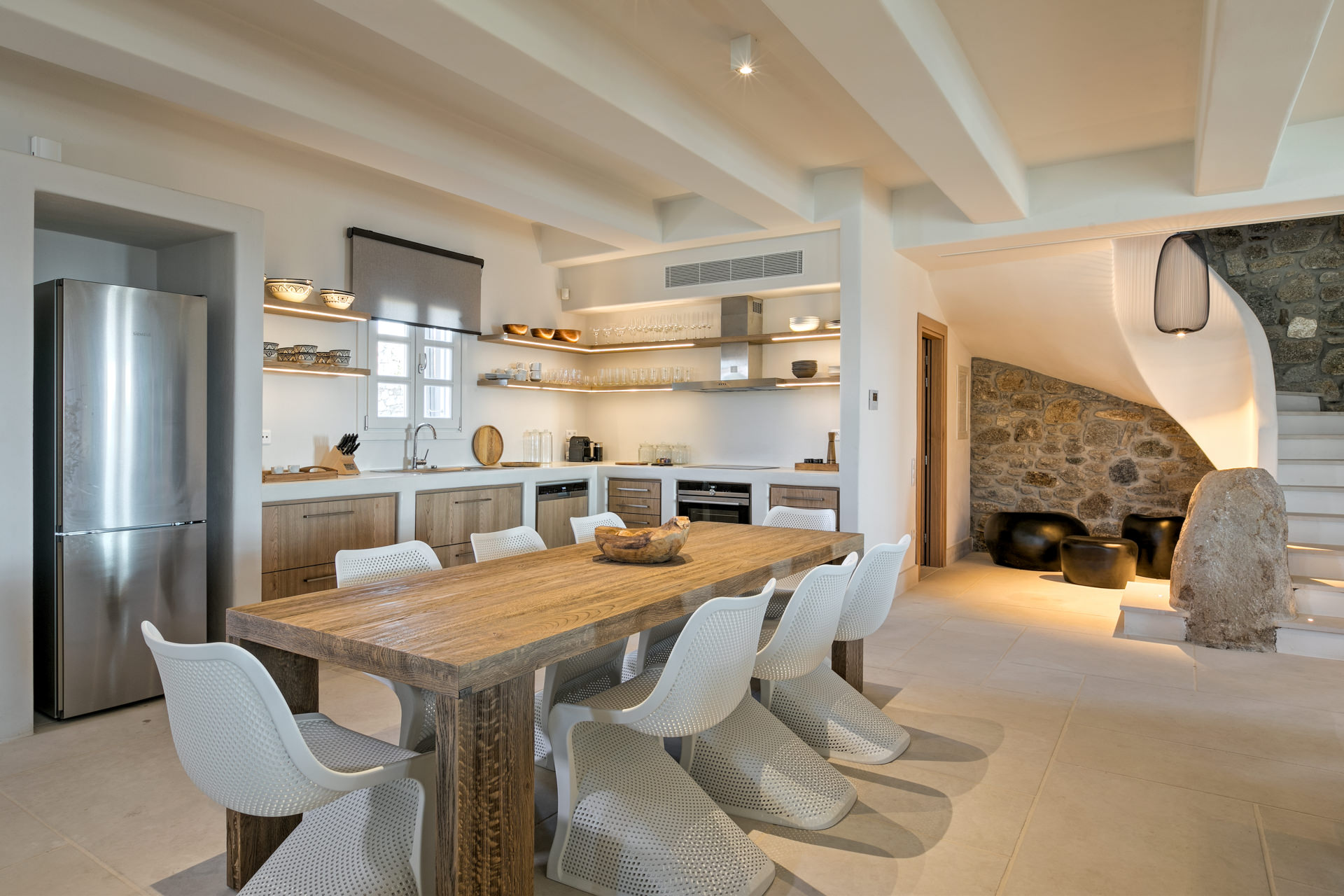 Dining table, kitchen and staircase at Villa Arion in Aleomandra, Mykonos