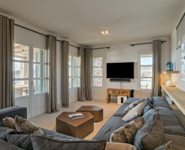 TV room with sofas at Villa Arion in Aleomandra, Mykonos