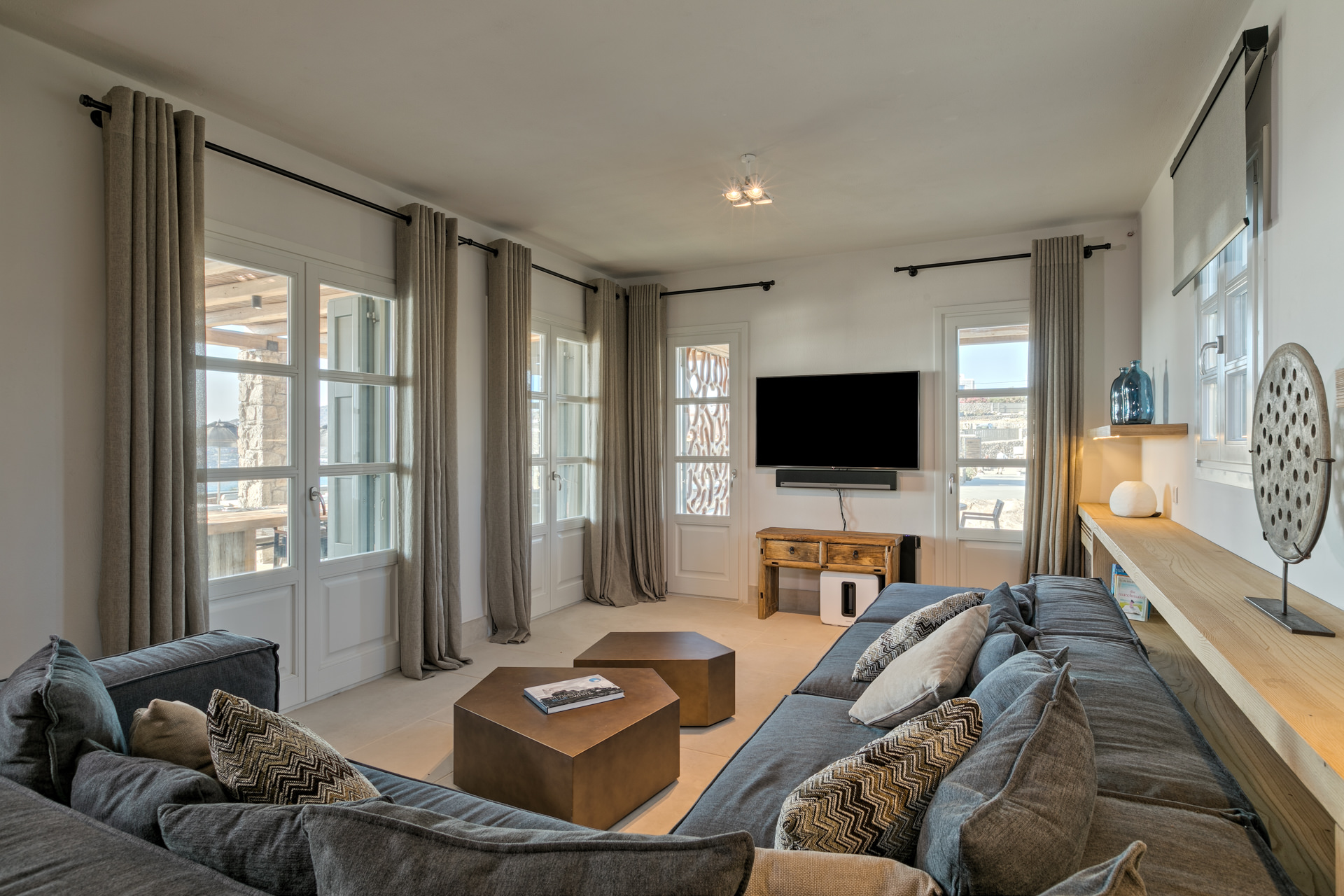 TV room with sofas at Villa Arion in Aleomandra, Mykonos