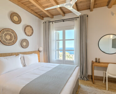Double bedroom with wall baskets at Villa Arion in Aleomandra, Mykonos