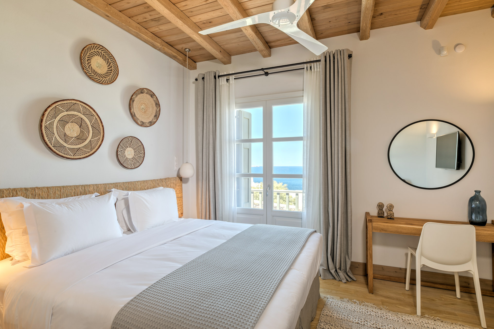 Double bedroom with wall baskets at Villa Arion in Aleomandra, Mykonos