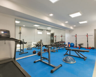 Gym with treadmill and weights at Villa Arion in Aleomandra, Mykonos