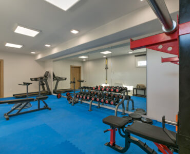 Gym with weights and bench at Villa Arion in Aleomandra, Mykonos