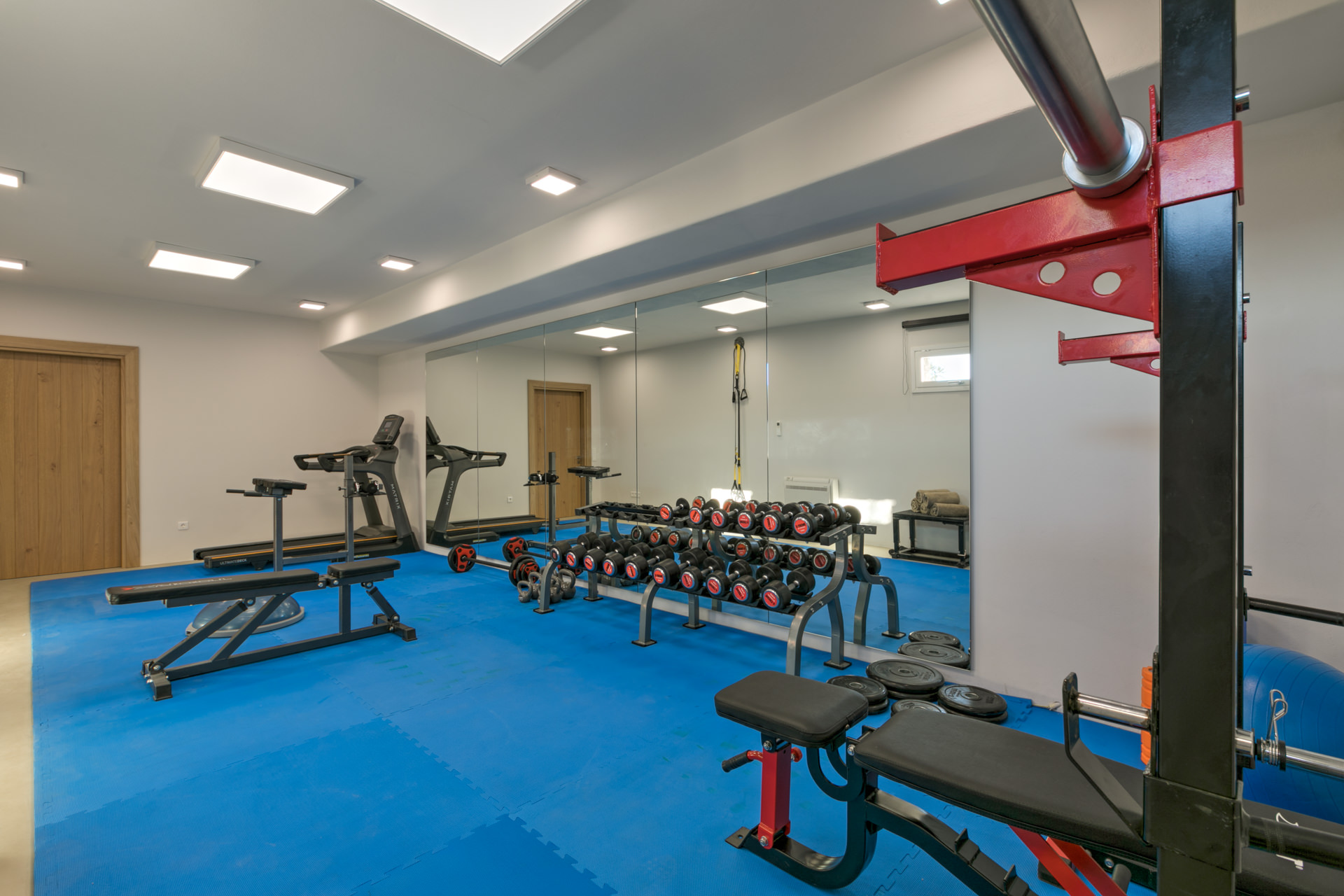 Gym with weights and bench at Villa Arion in Aleomandra, Mykonos