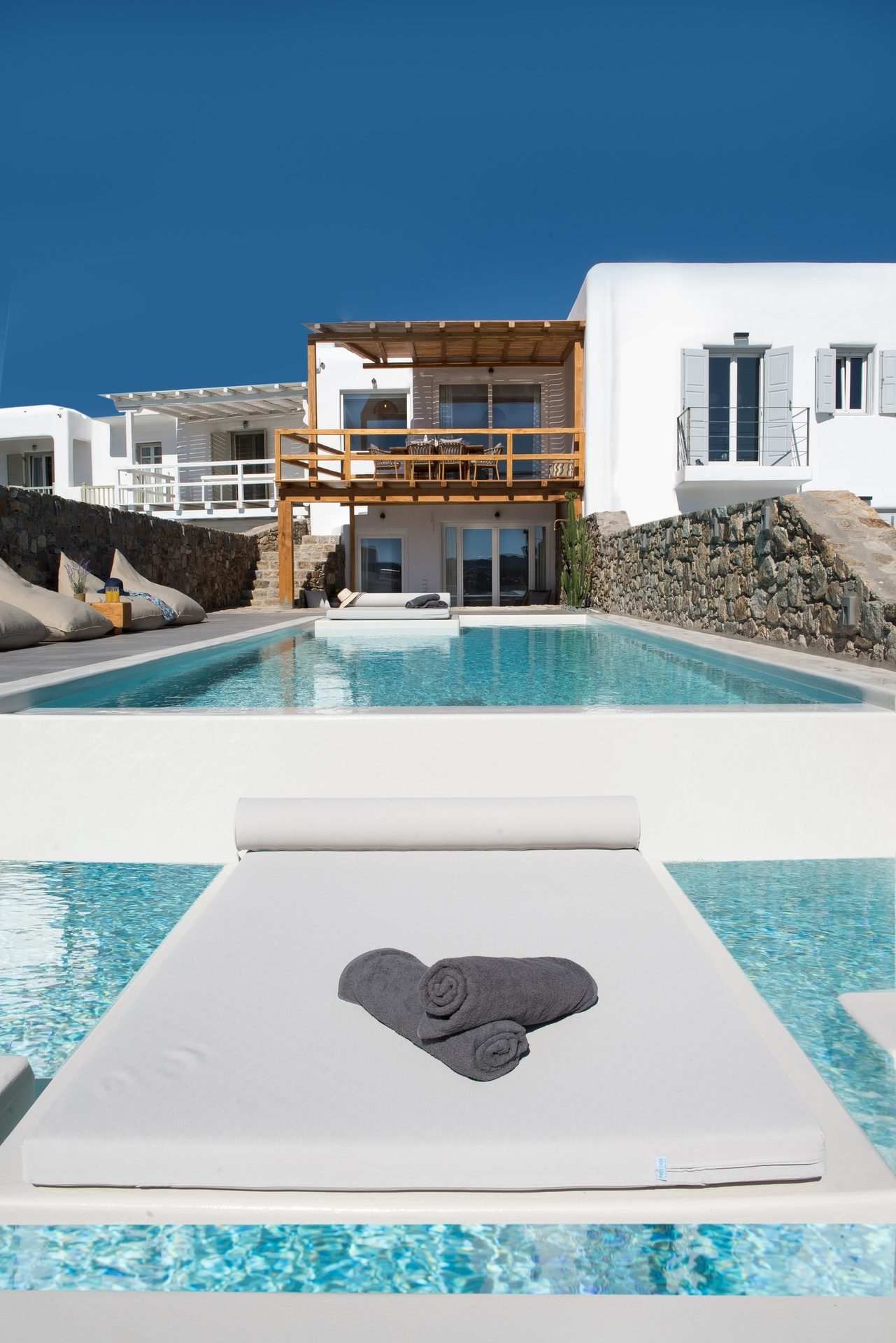 Pool with in-water sun deck at Villa Costa in Elia, Mykonos