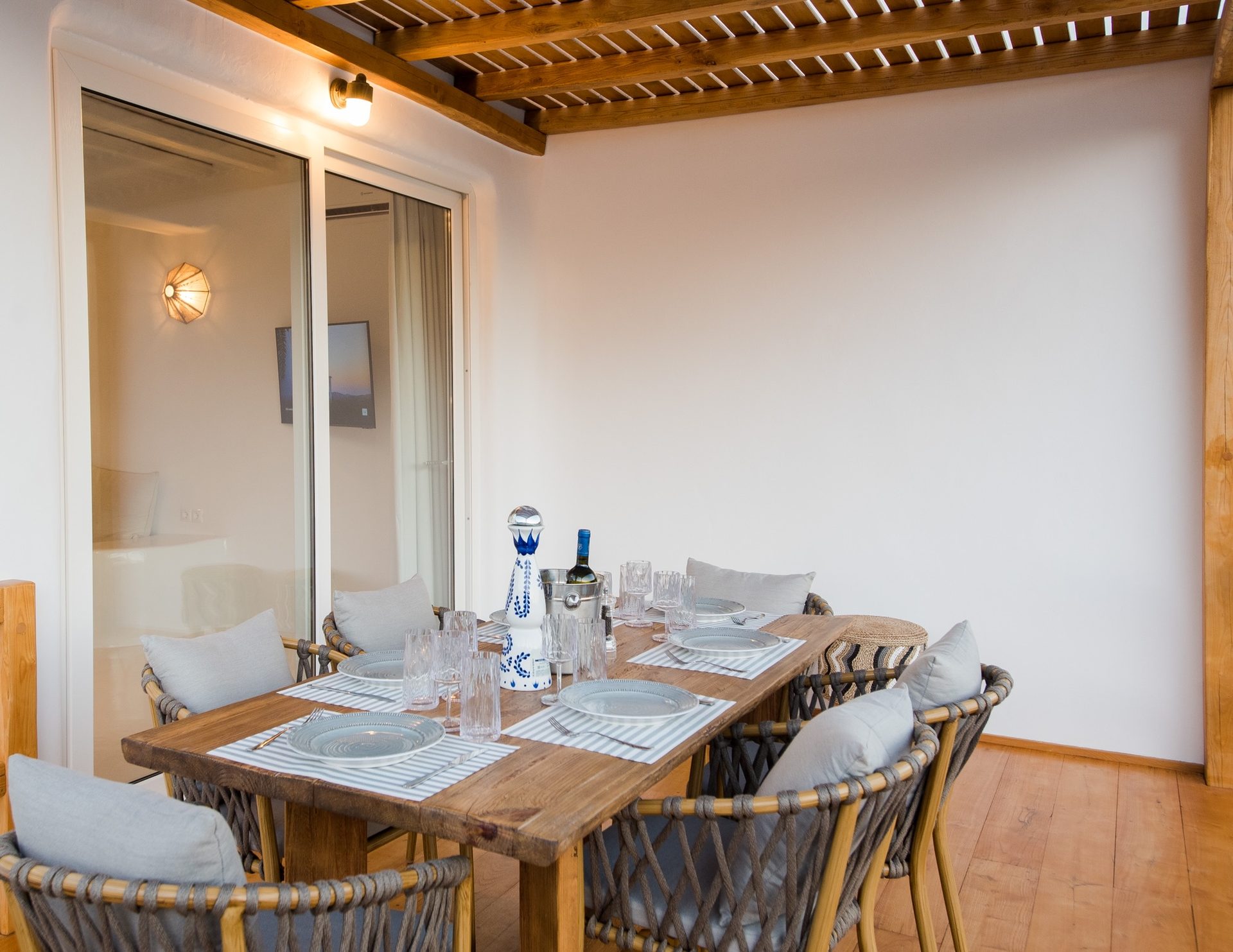 Dining area under the wooden ceiling at Villa Costa in Elia, Mykonos