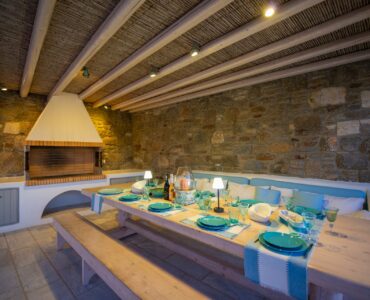 Pergola dining area with stone wall at Villa Danelina in Agios Lazaros, Mykonos