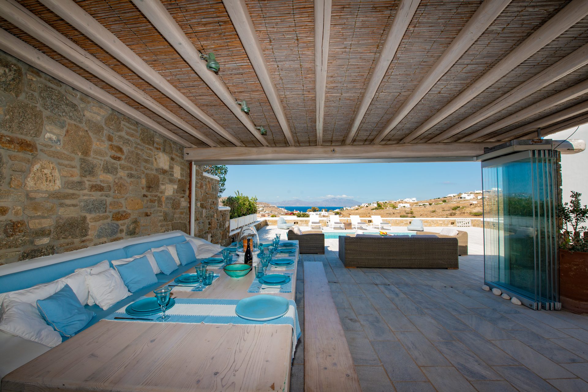 Covered lounge with built-in sofas at Villa Danelina in Agios Lazaros, Mykonos