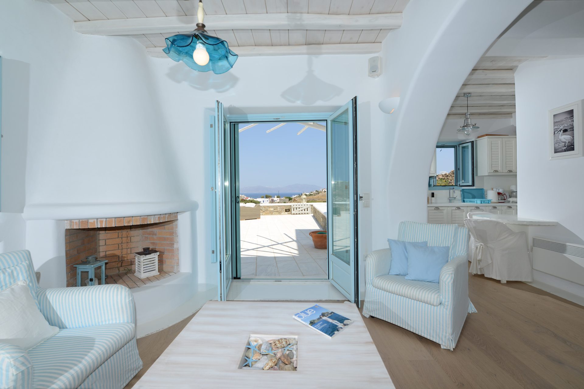 Living room with sea-view door at Villa Danelina in Agios Lazaros, Mykonos