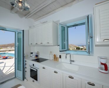 Kitchen with sea-view window at Villa Danelina in Agios Lazaros, Mykonos