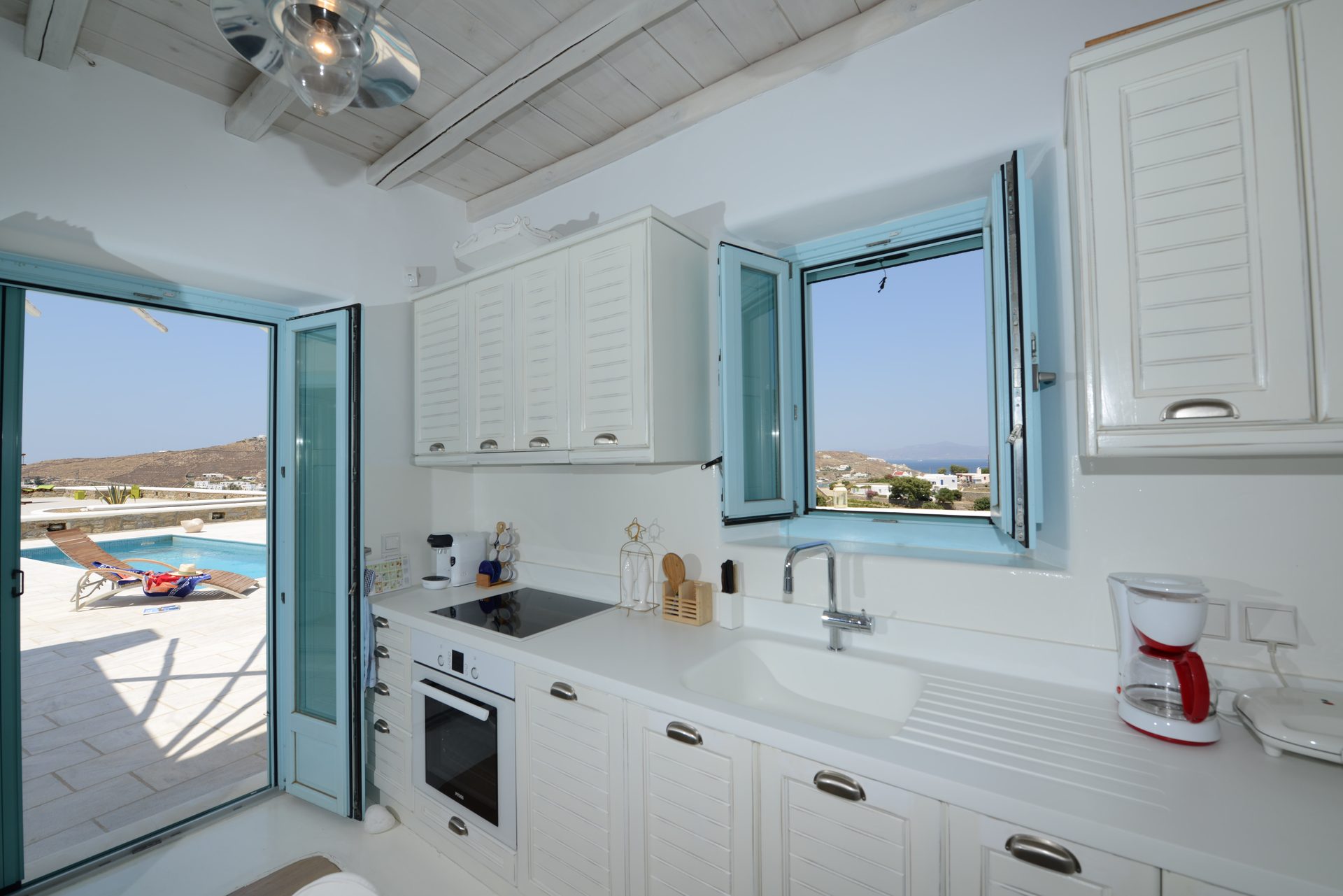 Kitchen with sea-view window at Villa Danelina in Agios Lazaros, Mykonos