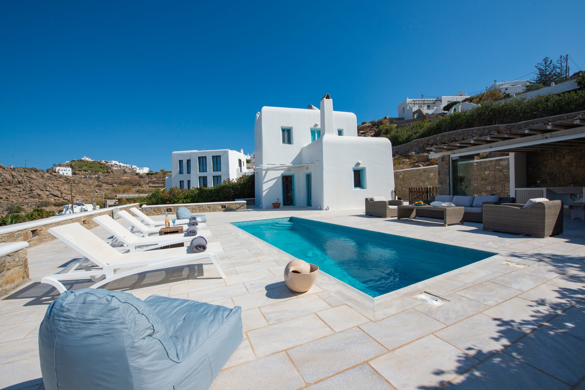 Pool terrace with sun loungers at Villa Danelina in Agios Lazaros, Mykonos