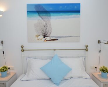 Double bedroom with artwork at Villa Danelina in Agios Lazaros, Mykonos