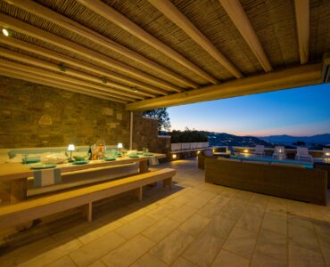 Covered dining terrace at dusk at Villa Danelina in Agios Lazaros, Mykonos