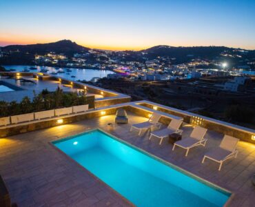 Pool with view of the bay at dusk at Villa Danelina in Agios Lazaros, Mykonos