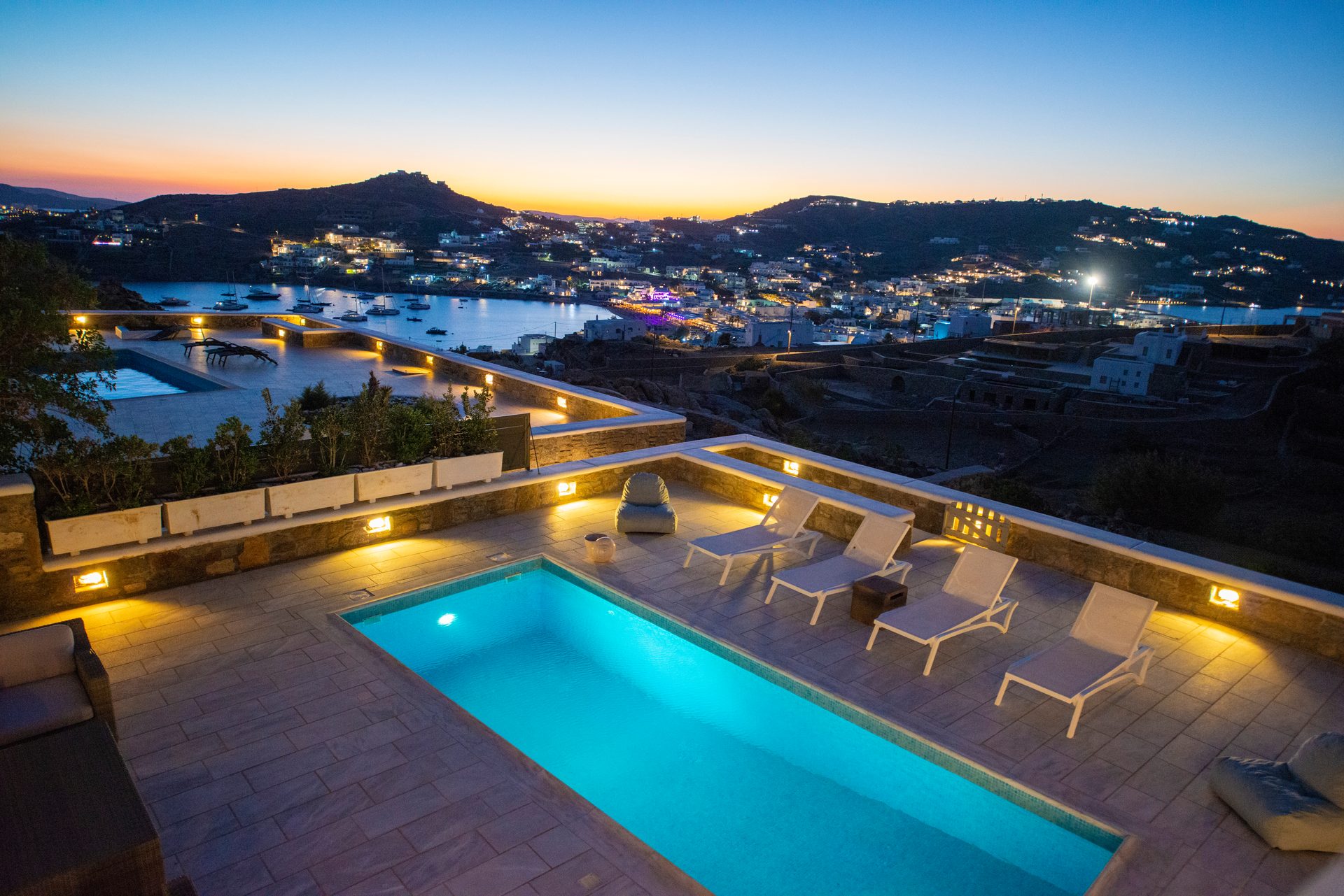 Pool with view of the bay at dusk at Villa Danelina in Agios Lazaros, Mykonos