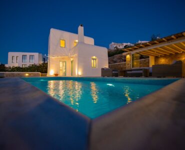 Villa and lit pool at dusk at Villa Danelina in Agios Lazaros, Mykonos