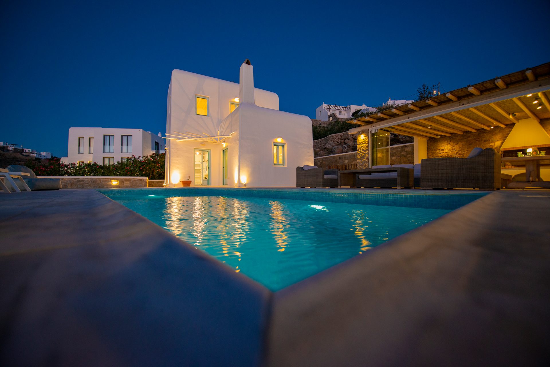 Villa and lit pool at dusk at Villa Danelina in Agios Lazaros, Mykonos