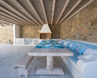 Dining table under the wooden pergola at Villa Danelina in Agios Lazaros, Mykonos
