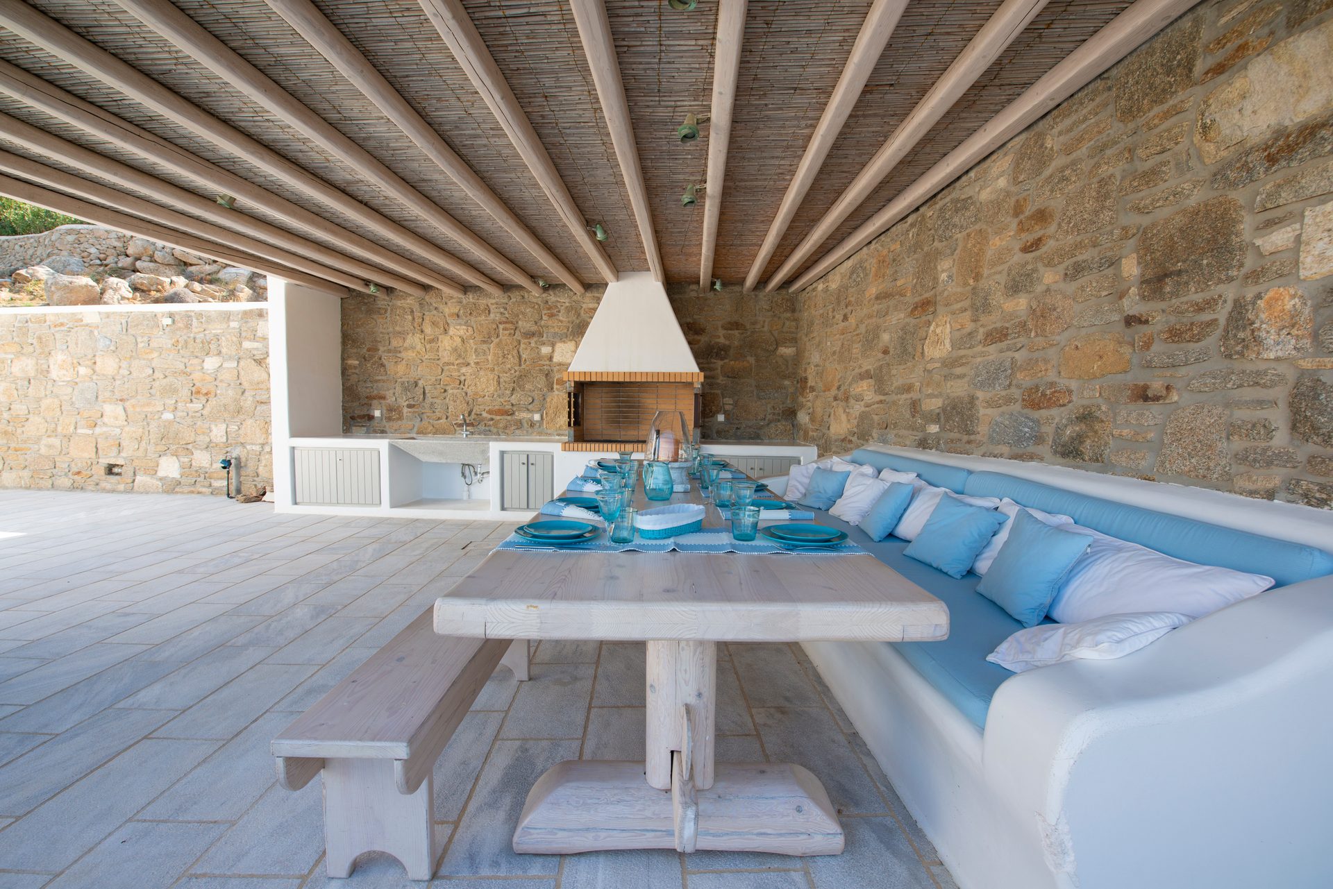 Dining table under the wooden pergola at Villa Danelina in Agios Lazaros, Mykonos