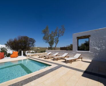 Pool with sun loungers at Villa Gaia in Psarou, Mykonos