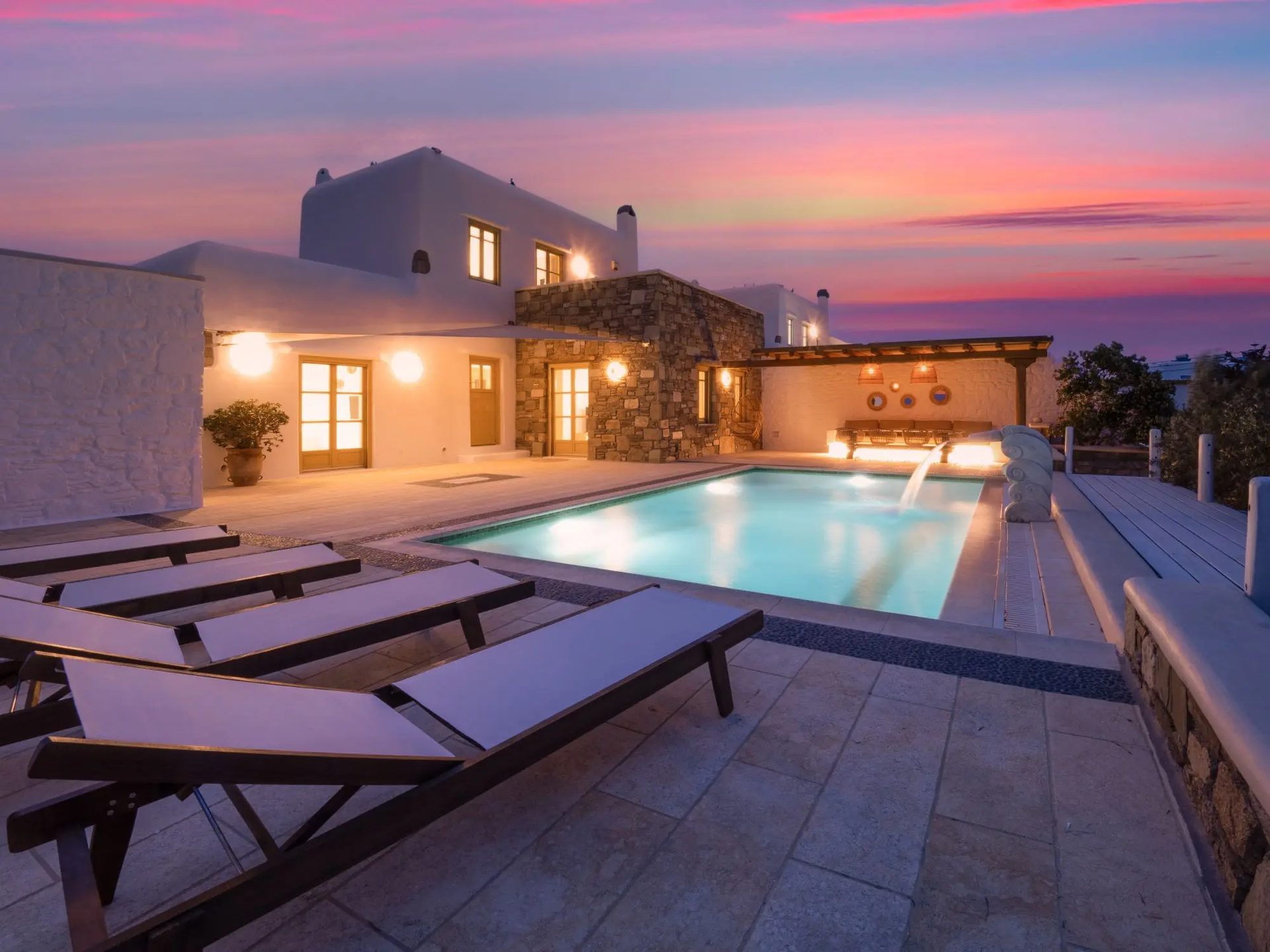 Pool terrace at sunset at Villa Gaia in Psarou, Mykonos