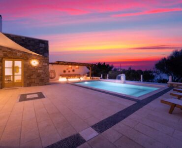 Pool terrace at dusk at Villa Gaia in Psarou, Mykonos