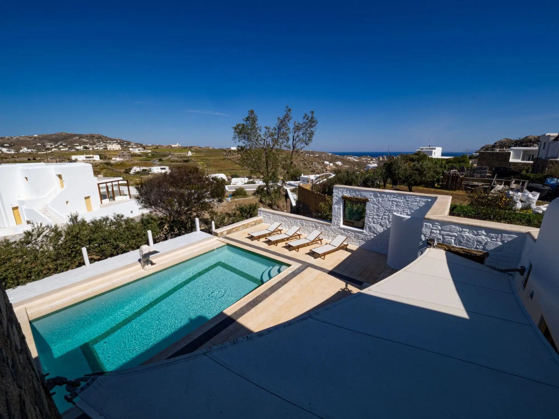 Pool and countryside views from above at Villa Gaia in Psarou, Mykonos