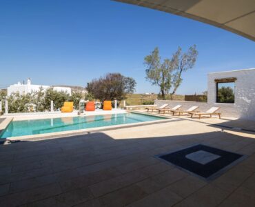 Pool terrace from the shaded veranda at Villa Gaia in Psarou, Mykonos