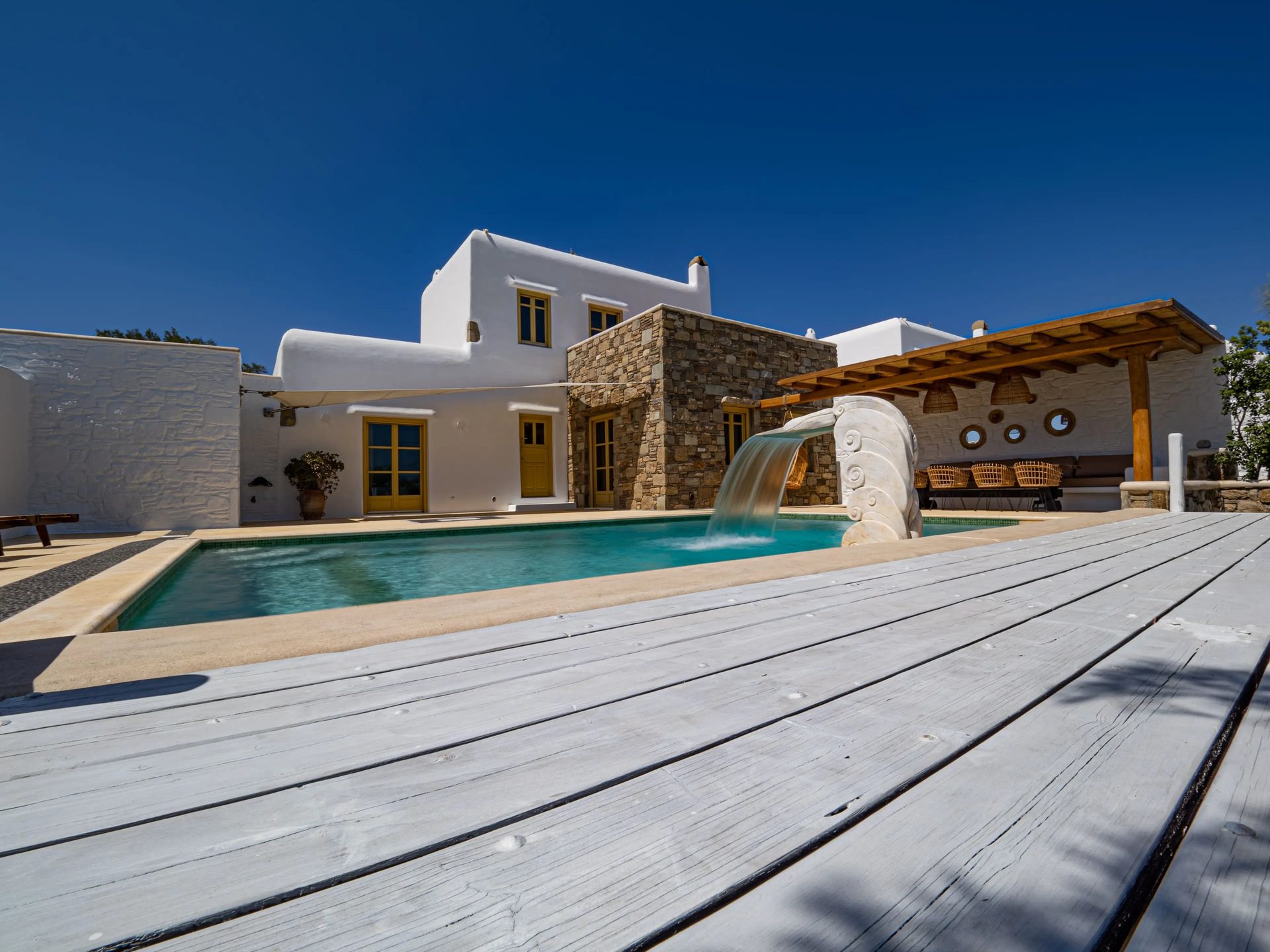 Pool and wooden pergola at Villa Gaia in Psarou, Mykonos