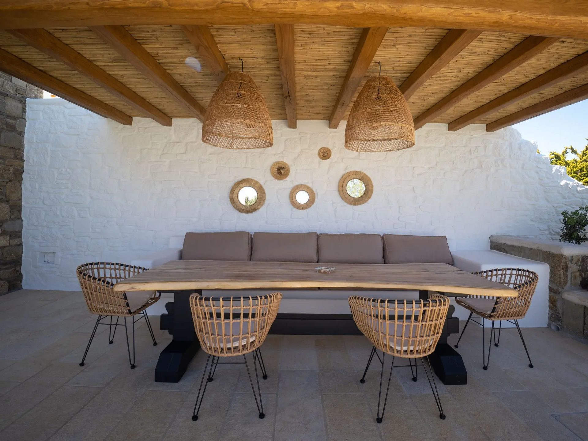 Outdoor dining table under the pergola at Villa Gaia in Psarou, Mykonos