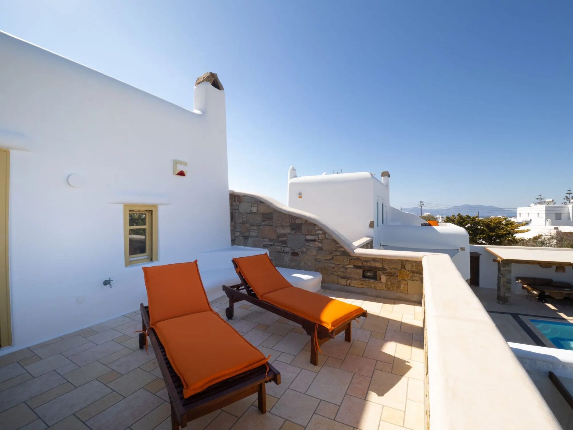 Sun loungers on the upper terrace at Villa Gaia in Psarou, Mykonos