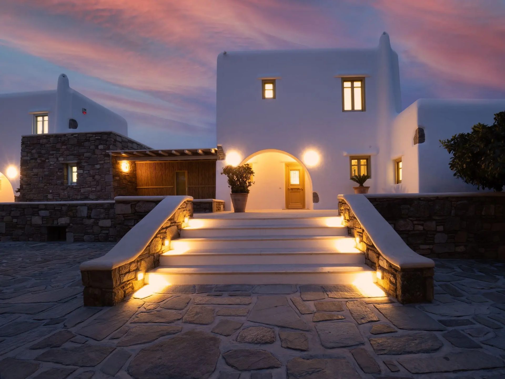 Entrance steps lit at dusk at Villa Gaia in Psarou, Mykonos