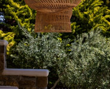 Garden detail with rattan lamp at Villa Gaia in Psarou, Mykonos