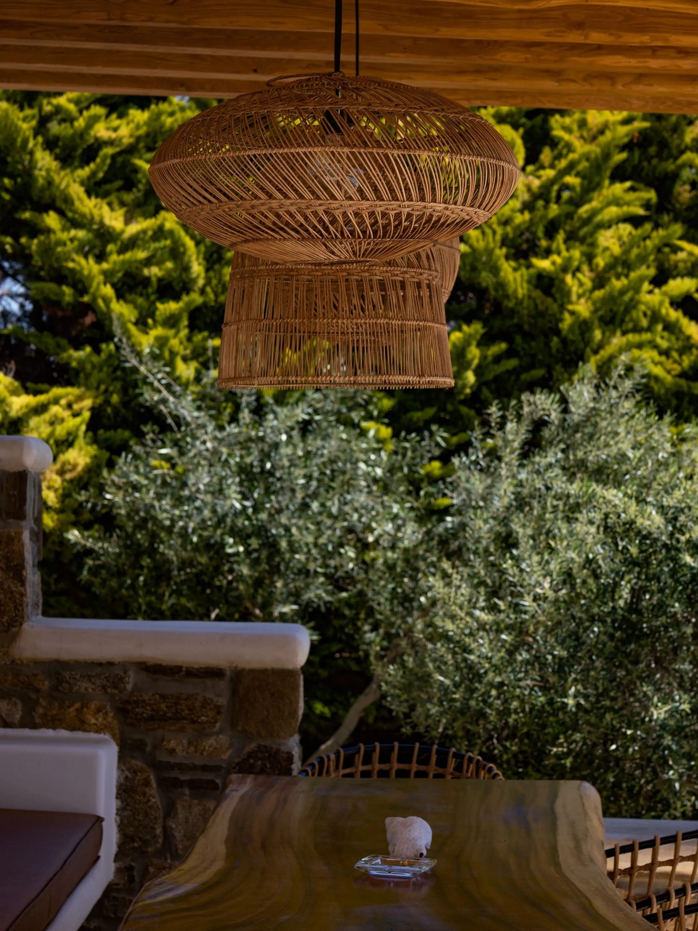 Garden detail with rattan lamp at Villa Gaia in Psarou, Mykonos