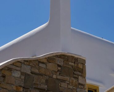 Cycladic chimney and stone wall at Villa Gaia in Psarou, Mykonos
