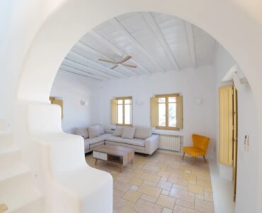 Living room seen through an arch at Villa Gaia in Psarou, Mykonos