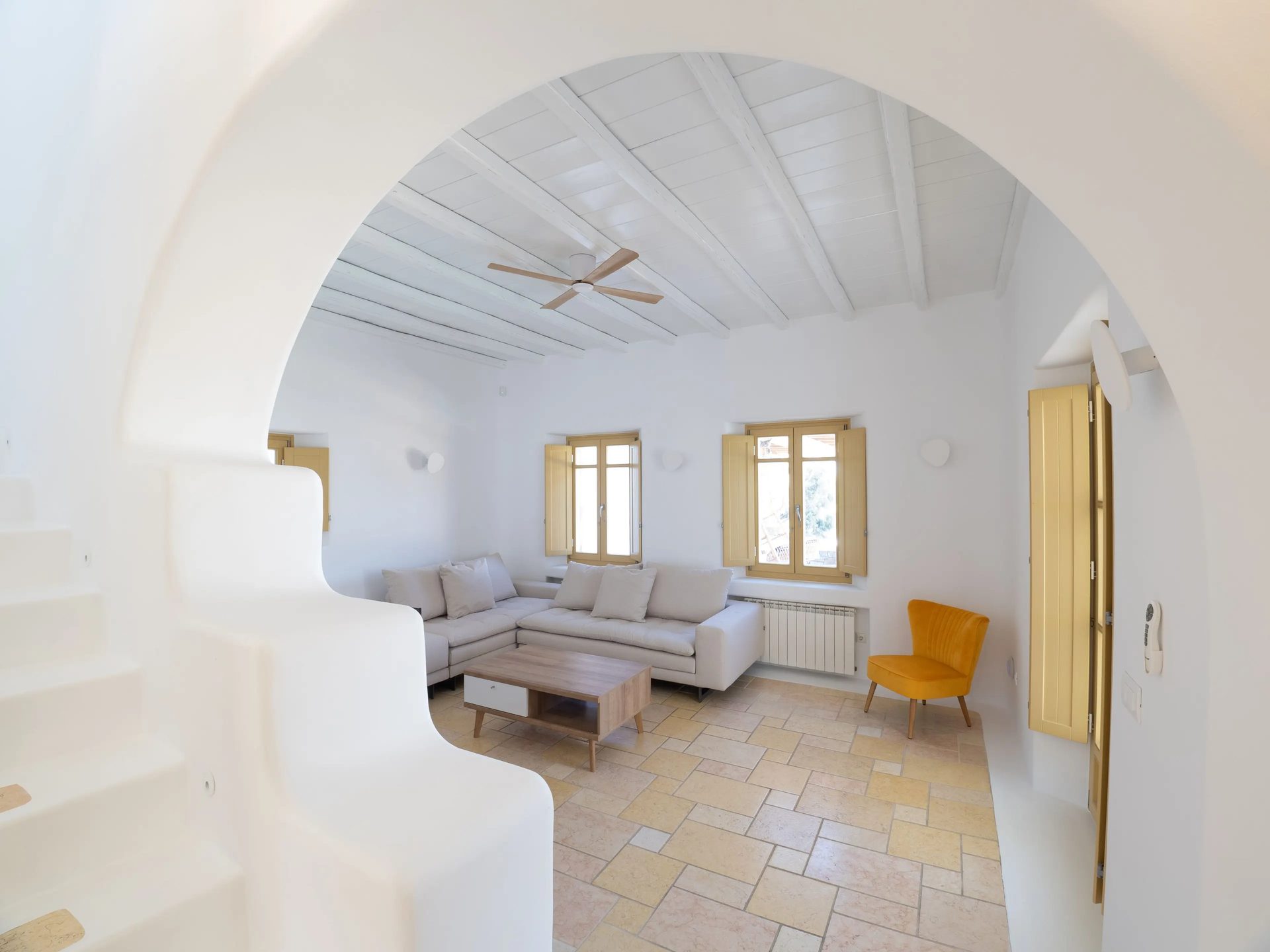 Living room seen through an arch at Villa Gaia in Psarou, Mykonos