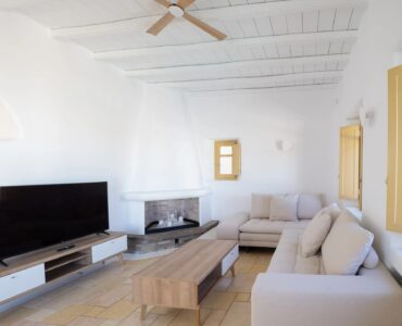 Living room with TV at Villa Gaia in Psarou, Mykonos